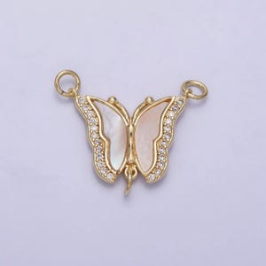 May include: Gold butterfly charm with a white mother of pearl inlay and clear crystal accents.