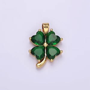 May include: A gold-tone pendant featuring a four-leaf clover design with green crystal accents.