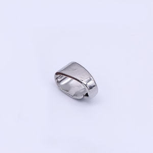 May include: A silver-colored ring with a rectangular face. The ring has a smooth, polished surface and a simple, modern design. The ring is set against a white background.