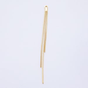 May include: A gold-colored jewelry component with a loop at the top and three dangling chains. The chains are thin and textured, creating a delicate, elegant appearance. The component is designed for jewelry making.