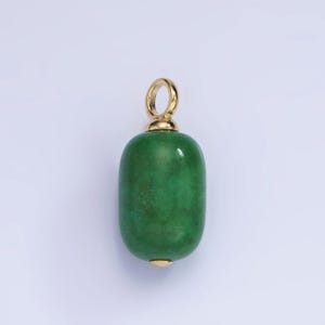 May include: A green gemstone pendant with a gold bail. The gemstone is oval shaped and has a smooth, polished surface.
