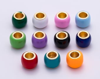 May include: A collection of colorful, round beads with gold-colored interiors. The beads are in various colors, including green, white, pink, blue, green, purple, black, navy, red, teal, and orange. These beads are suitable for jewelry making.