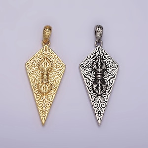 May include: Two ornate pendants, one gold and one silver, shaped like a diamond with intricate designs and a central symbol.