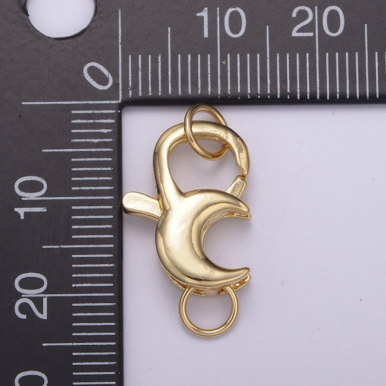 May include: Gold-toned metal lobster clasp with a spring-loaded closure. The clasp is approximately 1 inch in length.