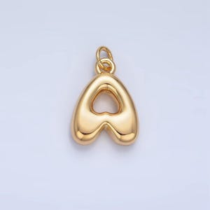 May include: A gold-colored charm in the shape of the letter A. The charm has a hollow center in the shape of a heart.