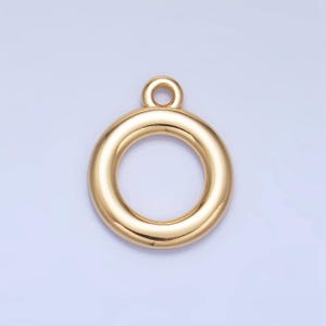 May include: Gold-toned metal ring pendant with a smooth, rounded surface. The ring has a small loop at the top for attaching to a chain or cord.