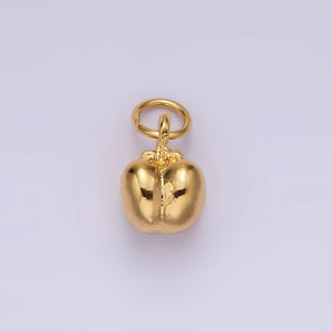 Könnte beinhalten: Ein goldfarbener Anhänger in Form einer Paprika. Der Anhänger hat oben eine Öse zum Anbringen an einer Halskette oder einem Armband.