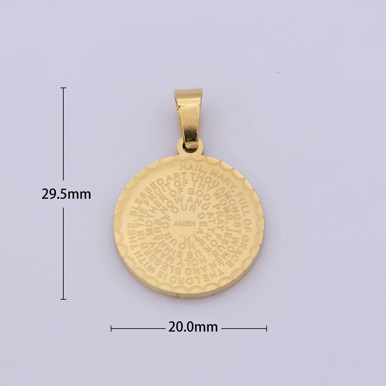 May include: Gold-toned metal pendant with a circular design featuring the text "Hail, Mary, full of grace..." in a circular pattern. The pendant measures 2.95 cm in diameter.