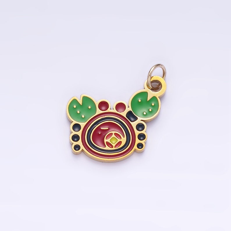 Op de afbeelding: Gouden metalen hanger met een rood, groen en zwart emaille ontwerp van een krab. De hanger heeft een lus aan de bovenkant om aan een ketting of armband te bevestigen.
