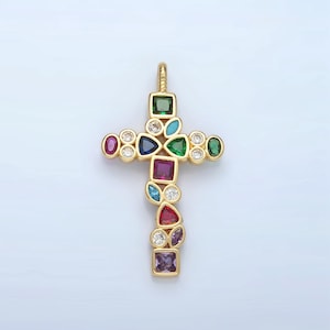 May include: A gold cross pendant with a variety of colorful gemstones, including red, blue, green, and purple.