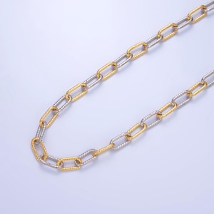 May include: A gold and silver chain necklace with a linked design. The chain is made of two different metals, with one half being gold and the other half being silver.