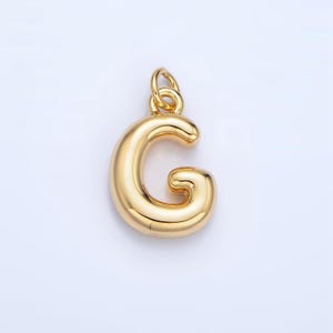 May include: Gold-colored letter G charm pendant. The letter is stylized with a rounded, bubbly design.