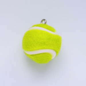 May include: A yellow and white tennis ball ornament with a silver loop for hanging.
