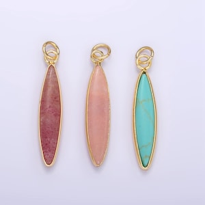 May include: Three gold-plated pendants with different colored stones. The pendants are oval-shaped and have a loop at the top for attaching to a chain. The stones are pink, red, and turquoise.
