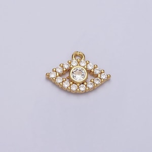May include: Gold evil eye charm with clear rhinestones. The charm has a single larger clear rhinestone in the center.