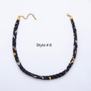 May include: Braided black necklace with gold-colored accents and a chain clasp. The necklace features a pattern of yellow, blue, and white shapes. The text "Style # 6" is visible.