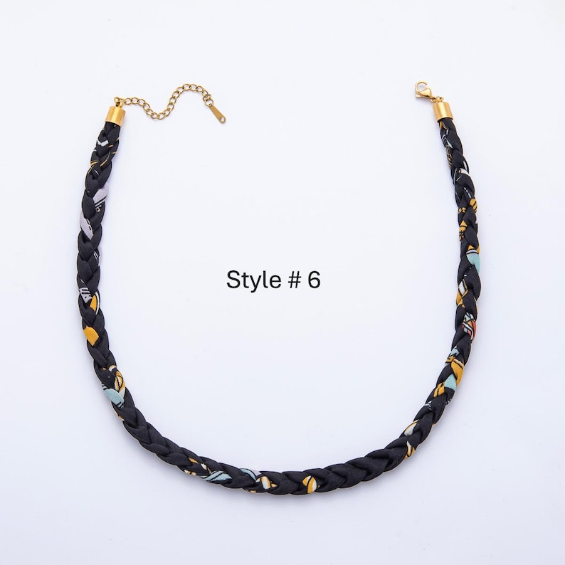 May include: Braided black necklace with gold-colored accents and a chain clasp. The necklace features a pattern of yellow, blue, and white shapes. The text "Style # 6" is visible.