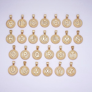 Könnte beinhalten: Ein Set mit 26 goldfarbenen Anhängern, jeder mit einem anderen Buchstaben des Alphabets, verziert mit funkelnden Strasssteinen. Die Anhänger sind perfekt, um personalisierten Schmuck zu kreieren.