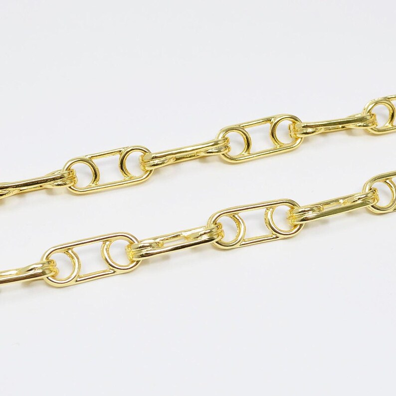 May include: A gold chain necklace with a linked pattern of oval and round shapes.