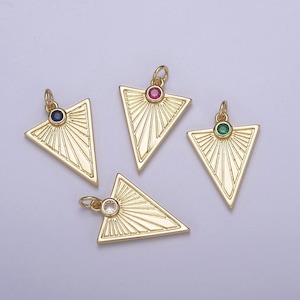 May include: Four gold triangle pendants with a sunburst design and a single gemstone in the center. The gemstones are blue, red, green, and clear.