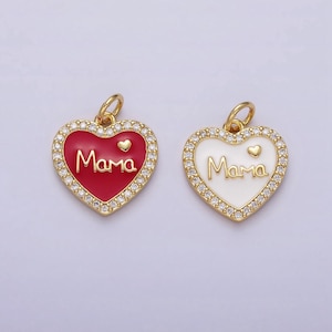 May include: Two gold heart-shaped charms with a white and red enamel finish. Both charms feature the word "Mama" and a small heart. The charms are surrounded by a border of clear rhinestones.