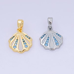 May include: Two seashell pendants, one gold-toned and one silver-toned. Both pendants feature a shell design with blue gemstone accents. The gold pendant has a polished finish, while the silver pendant has a shiny finish.