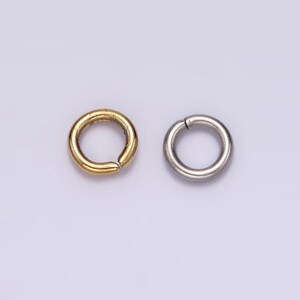 May include: Two jump rings, one gold and one silver, are shown against a white background. The jump rings are open and ready to be used for jewellery making.