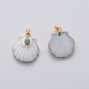 May include: Two seashell pendants with gold-colored trim and bails. One pendant features a small turquoise stone. The shells are white with a ridged texture. The pendants are likely for jewelry making or crafting.