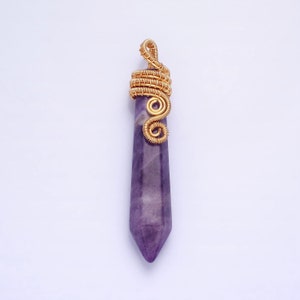 May include: A purple amethyst point pendant with a gold wire wrapped bail. The wire is wrapped in a spiral design.