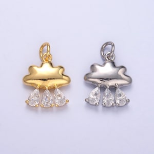 May include: Two cloud-shaped charms with three teardrop-shaped crystals hanging from each. The charm on the left is gold, and the charm on the right is silver.