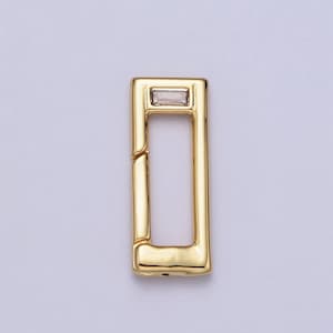 May include: Gold-toned metal clasp with a clear rectangular stone in the center.