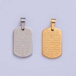 May include: Two silver and gold dog tag pendants with a Christian prayer engraved on each. The prayer is in Spanish and includes a cross.