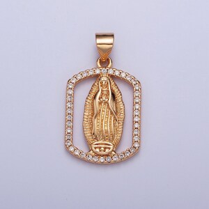 May include: Gold pendant necklace featuring a detailed image of the Virgin Mary surrounded by clear cubic zirconia stones.