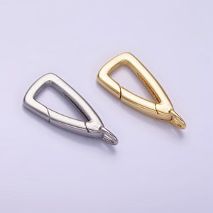 May include: Two triangle-shaped metal clasps, one silver and one gold, with a spring-loaded opening.