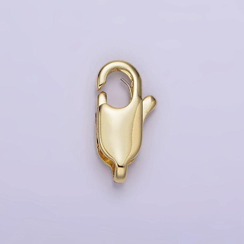 May include: Gold-toned metal lobster clasp for jewelry making. The clasp is a simple, functional design with a smooth finish.