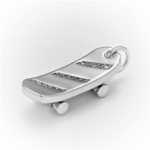 May include: A silver skateboard charm with a detailed design and a small loop for attaching to a bracelet or necklace.