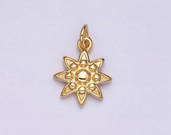 May include: A gold-colored charm in the shape of a starburst. The charm has a loop at the top for attaching to a chain or bracelet. The starburst design features pointed rays and small, round accents.