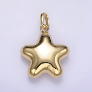 May include: A gold-tone star-shaped pendant charm. The charm is smooth and has a shiny finish.