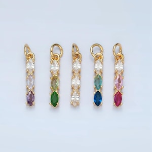 May include: Five gold charms with a row of clear and colored marquise-shaped stones. The charms are in a rainbow color order: purple, green, clear, blue, and red.
