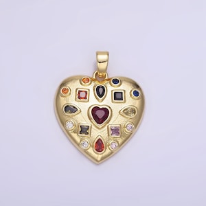 Peut inclure: Un pendentif en forme de cœur en or avec un cœur rouge au centre et entouré de petites pierres précieuses colorées.
