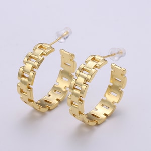 May include: A pair of gold hoop earrings with a chain link design.
