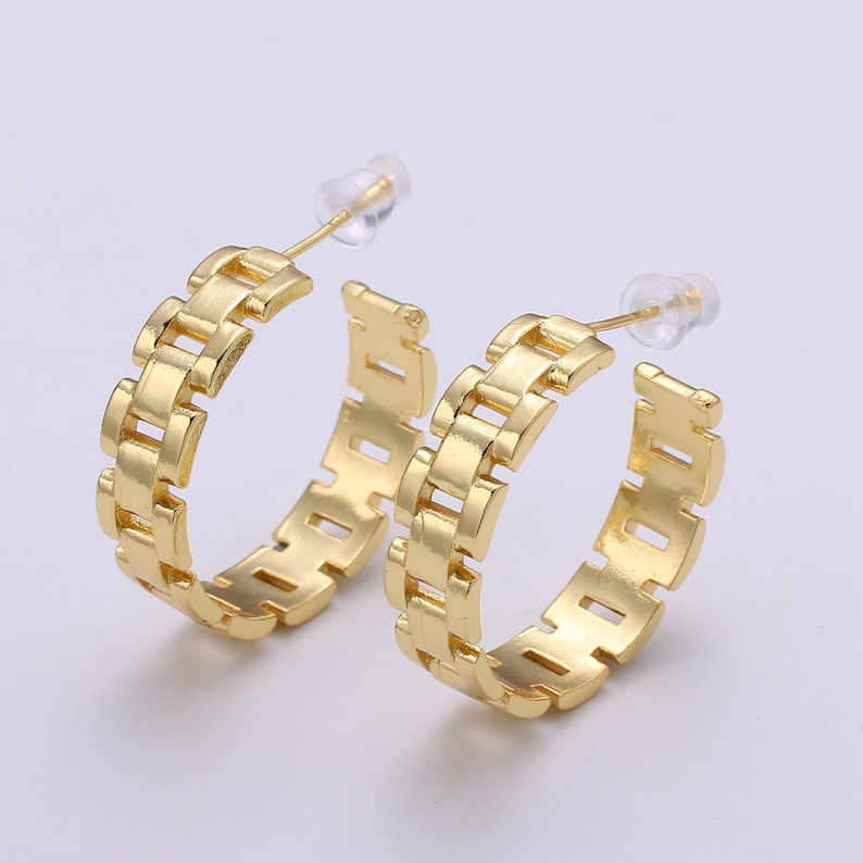 May include: A pair of gold hoop earrings with a chain link design.