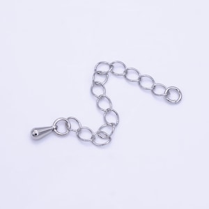 May include: Silver chain extender with a teardrop-shaped end piece.