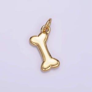 May include: A gold-colored bone-shaped charm pendant.