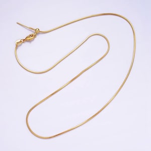 May include: A gold snake chain necklace with a lobster clasp.
