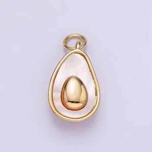 May include: A gold-tone avocado charm with a white shell-like center and a gold-tone pit.