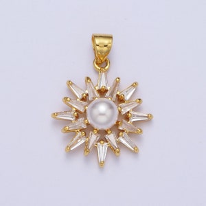 May include: A gold pendant featuring a pearl surrounded by clear cubic zirconia stones in a sunburst design.