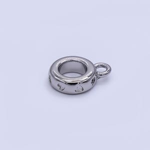 May include: A shiny, silver-colored charm with a circular design and a small loop. The charm has heart-shaped cutouts around the outer edge. This jewelry component is suitable for necklaces, bracelets, and other DIY jewelry projects.