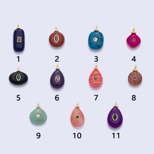 May include: Eleven gemstone pendants with gold-coloured bails. The pendants are in various shapes and colours, including blue, red, turquoise, pink, green, and purple. Each pendant has a small, contrasting gemstone or design element.