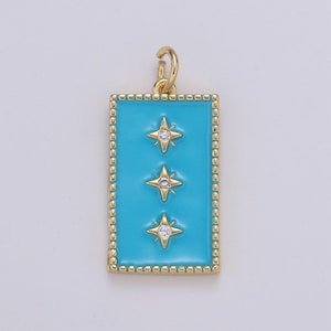 May include: A gold pendant charm with a turquoise blue enamel rectangle and three gold stars with clear rhinestones.